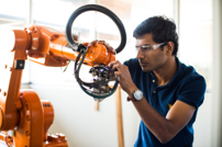 Engineering Student with robotics machinery